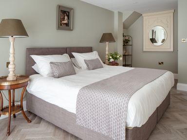 A bedroom with a bed and bedside table at The School House in Newton Abbot