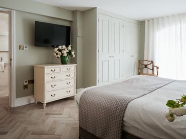 A bedroom with a bed and dresser at The School House in Newton Abbot