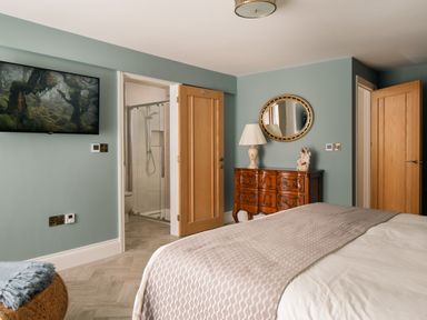 A bedroom with a bed and a cabinet at The School House in Newton Abbot