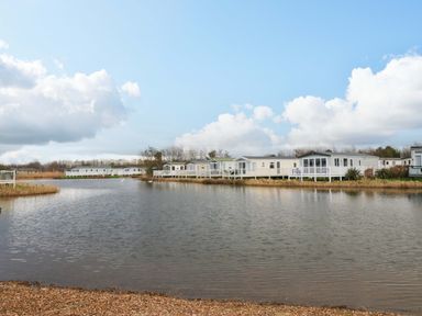 A view of caravans by a lake at 62 Guddlebeck in Flookburgh