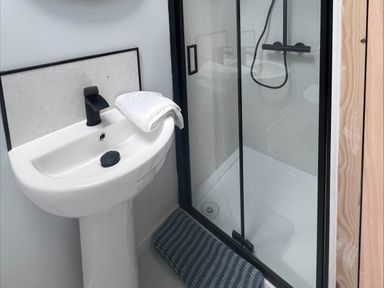A bathroom featuring a sink and a shower enclosure at 81 Lon Gogarth in Benllech