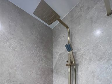 A shower setup with a rainfall shower head at 81 Lon Gogarth Benllech