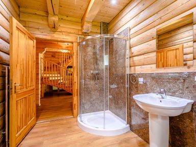A bathroom with a shower and sink at Foresters Spa Plus in Dundee