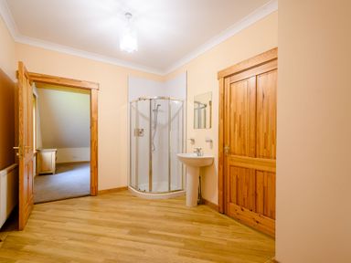 A bathroom with a shower and sink at Foresters Spa Plus in Dundee