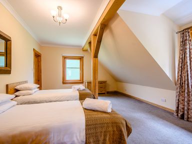 A bedroom with two beds and a window at Foresters Spa Plus in Dundee