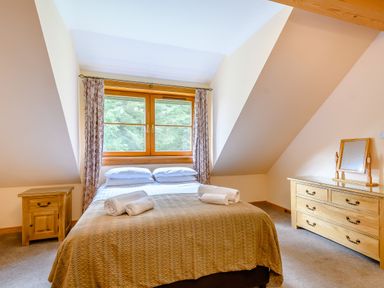 A bedroom with a bed and dresser at Foresters Spa Plus in Dundee