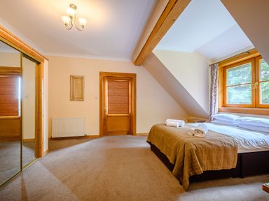 A bedroom with a bed and towels at Foresters Spa Plus in Dundee