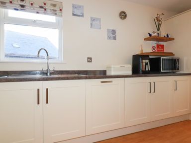 A kitchen with a sink and cabinets at 65 Benasa Lodge in Winnard's Perch near St Columb Major