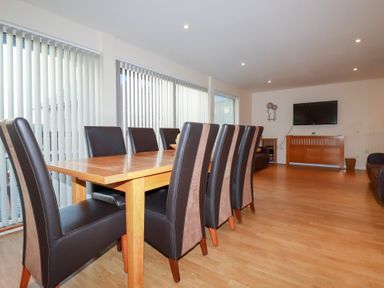 A dining room with a table and chairs at 65 Benasa Lodge near St Columb Major