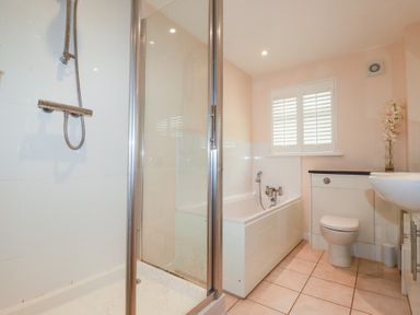 A bathroom with a shower and bathtub at 65 Benasa Lodge near St Columb Major