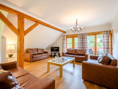 A living room with sofas and a coffee table at Eagle Spa Plus in Dundee