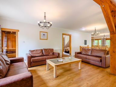 A living room with sofas and a coffee table at Eagle Spa Plus in Dundee