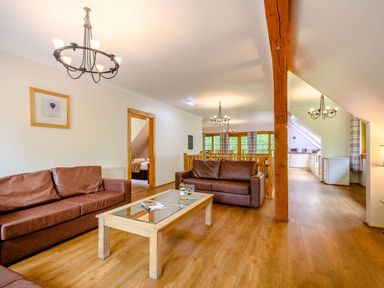 A living room with sofas and a coffee table at Eagle Spa Plus in Dundee