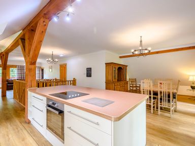 A kitchen with an island countertop and dining area at Eagle Spa Plus in Dundee