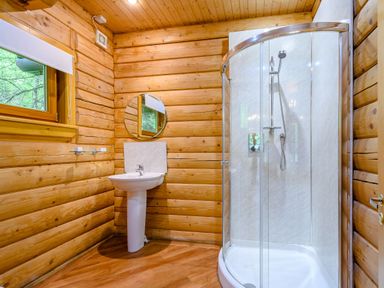 A bathroom with a shower, sink, and mirror at Eagle Spa Plus in Dundee