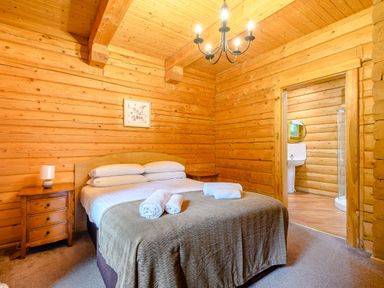 A bedroom with a bed and nightstand at Eagle Spa Plus in Dundee