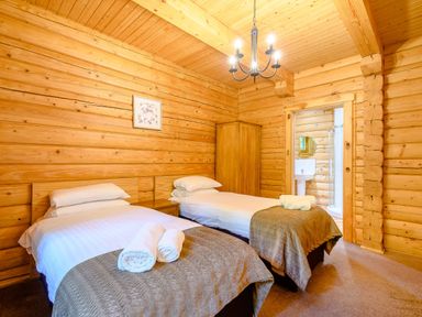 A bedroom with two beds and an ensuite bathroom at Eagle Spa Plus in Dundee