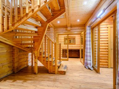 An entryway with a wooden staircase and windows at Eagle Spa Plus in Dundee