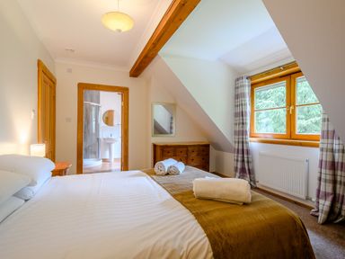 A bedroom with a bed and window at Eagle Spa Plus in Dundee