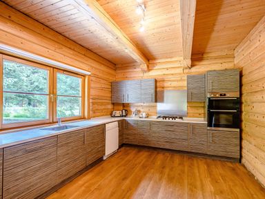 A kitchen with cabinets and appliances at Foresters Spa Plus (Pet) in Dundee