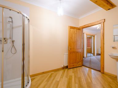 A bathroom with a shower and sink at Foresters Spa Plus (Pet) Dundee