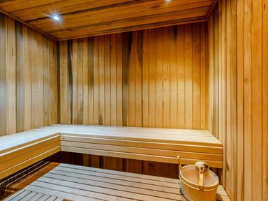 A sauna with wooden benches and a bucket at The Braveheart (Pet) Dundee