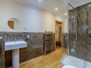 A bathroom with a shower and wash basin at Muirloch Spa Plus in Dundee