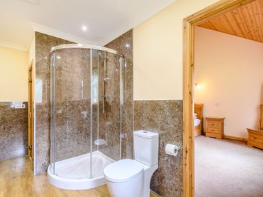 A bathroom with a shower and toilet at Muirloch Spa Plus in Dundee