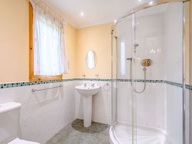 A bathroom with a shower and sink at Barnard Lodge (Pet) in Dundee