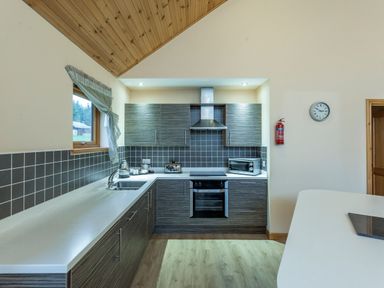 A kitchen with cabinets and appliances at Rainbow Spa Plus in Dundee