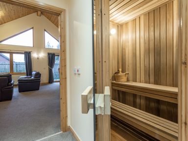 A sauna with wooden benches and a bucket at Rainbow Spa Plus in Dundee