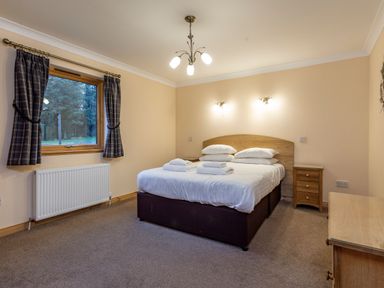 A bedroom with a bed and window at Rainbow Spa Plus in Dundee