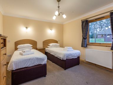 A bedroom with two beds and a window at Rainbow Spa Plus in Dundee