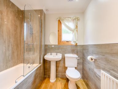 A bathroom with a shower and bathtub at Osprey Lodge in Dundee