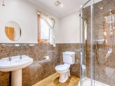 A bathroom with a sink, shower, and toilet at Osprey Lodge in Dundee