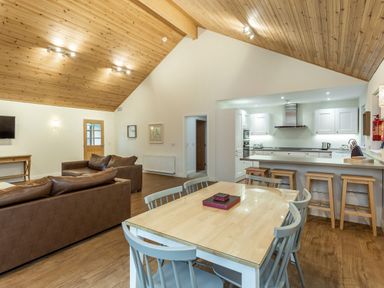 A living room with a dining area and kitchen at Galbraith Premier Spa in Dundee
