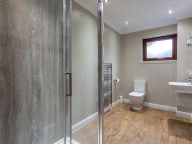 A bathroom with a shower, toilet, and sink at Galbraith Premier Spa in Dundee