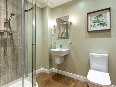 A bathroom with a shower, sink, and toilet at Galbraith Premier Spa (Pet) in Dundee