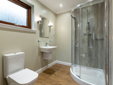 A bathroom with a shower, toilet, and sink at Galbraith Premier Spa (Pet) in Dundee