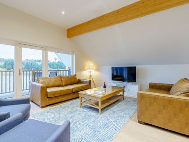 A living room with sofas, a coffee table and a television at Lochside Premier Spa (Pet) in Dundee
