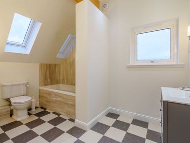 A bathroom with a toilet, bathtub, and sink at Lochside Premier Spa (Pet) in Dundee