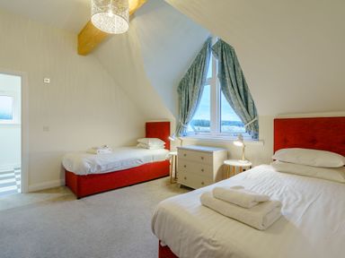 A bedroom with two beds and a window at Lochside Premier Spa (Pet) Dundee