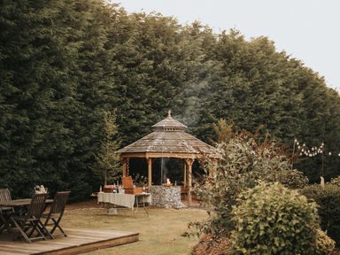 A gazebo and outdoor seating in a garden at Garden Pod VIP in Waltham