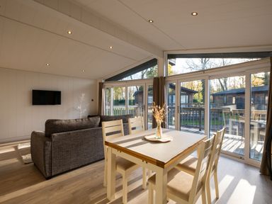 A living room with a dining table and sofa at Belfry in Waltham