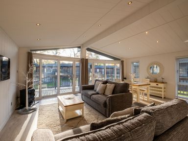 A living room with a sofa and table at Belfry in Waltham