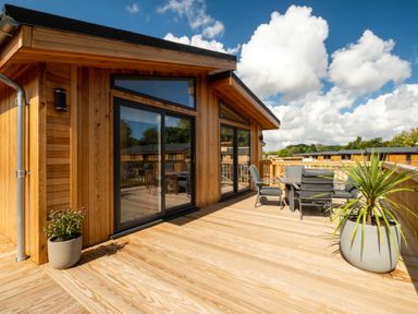 An outdoor deck with seating and plants at Moonlight Spa Luxury Waltham