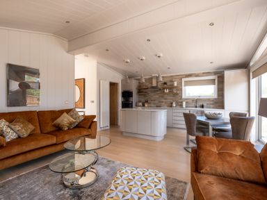 A living room with a kitchen island and dining area at Moonlight Spa Luxury in Waltham