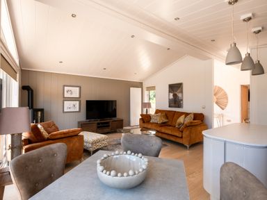 A living room with a sofa and television at Moonlight Spa Luxury Waltham