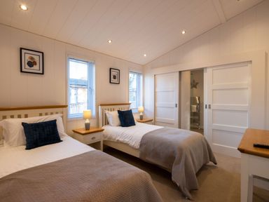 A bedroom with two beds and windows at Wentworth in Waltham