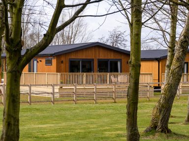 A wooden cabin with a deck at Royal View in Waltham